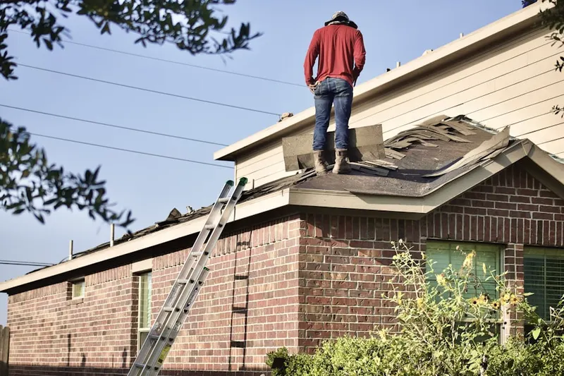 Professional roofer working on a residential roof in Downtown Mercer Island